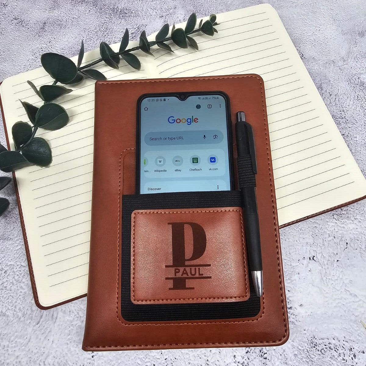 A Tan or Brown Leather Notebook (A5 size) with a phone holder pocket, engraved with a personal message. The notebook has 160 pages (80 sheets) of 70gsm, cream coloured, lined paper.